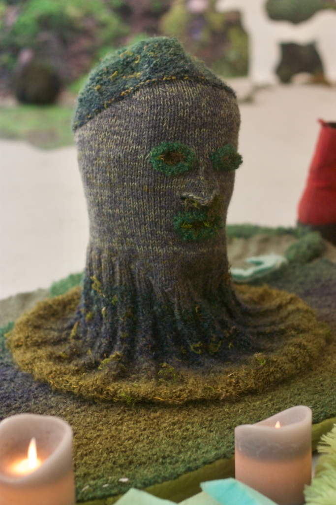 dark grey and green knitted head 